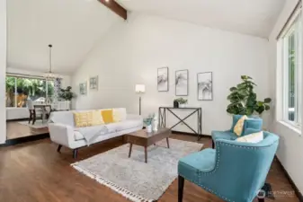 The formal living and dining rooms stretch out below the lofty vaulted ceiling.
