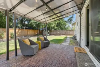 Beat the heat - or the rain - under this nice, covered patio that is just off the informal living room.