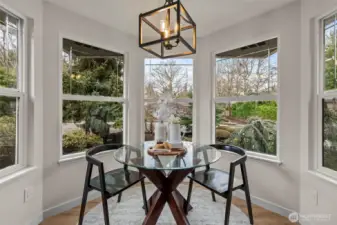 Bay windows fill this charming breakfast nook with fantastic light.