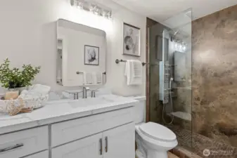 Stylishly updated main bathroom with a new vanity, mirror, lighting, and hardware.
