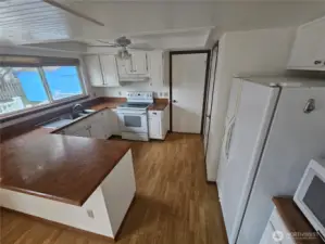 Great counterspace with room for stools.  Large pantry and door to the garage.