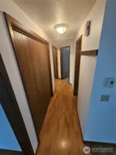 Down the hall to the 3 bedrooms, the hall bath and the en-suite bathroom in the primary bedroom.