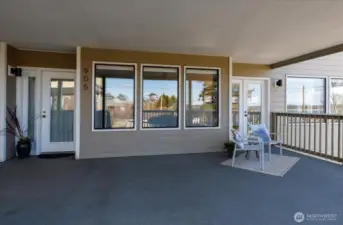 View from deck back to front door, left, and french doors to LR on right