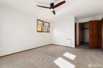 Primary bedroom showing entry, walk-in closet and door to ensuite bathroom