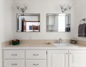 Spacious counter and double mirrors in primary bathroom