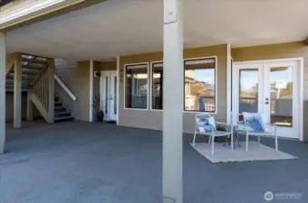 Large front deck, showing common area at far left, with stairs to upper two units.