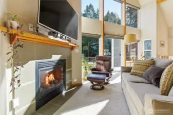 The indoor fireplace anchors the great room—perfect for cozy evenings beneath vaulted ceilings.