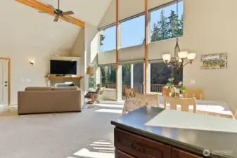 Stunning open-concept great room with soaring ceilings, exposed beams, and wonderful vertical space.