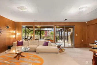 We'll get back to the main floor in a moment, but there's too much goodness in this daylight lower level to wait any longer.  Turning right at the base of the stairs we enter this fantastic family room which opens to the enclosed lower yard.