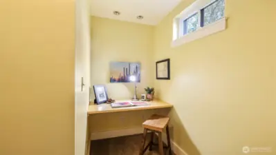 Landing at the bottom of the basement stairs with built in nook