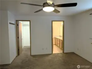 Primary bedroom with walk in closet & full primary bathroom with dual sinks. Say Yes to this address.  #7120 242nd St E, Graham, WA 98338. New carpet to be intalled prior to closing.