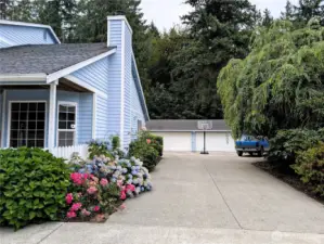 Lots of parking. 5 car detached covered parking plus 2 car attached garage. Say Yes to this address. #7120 242nd St E, Graham, WA 98338.