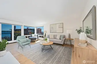 Sun filled living room with an open layout and expansive windows framing beautiful Lake Washington views.