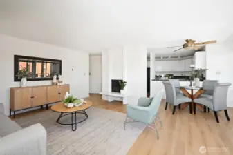 This light and airy space features seamless flow between the living room, dining area, and kitchen, creating an inviting open layout.
