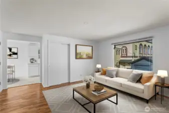 Unit E Living room looking into kitchen, virtually staged