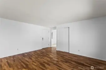 Additional view of Unit E Living room with original newly polished hardwood floors