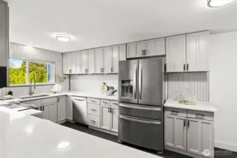 Fully updated kitchen at 4612 N 21st St, Tacoma, WA — featuring quartz countertops, modern shaker cabinets, stainless steel appliances, herringbone tile backsplash, and a bright window overlooking the backyard. This contemporary North Tacoma home offers a spacious, stylish, and functional kitchen ideal for cooking, entertaining, and everyday living.