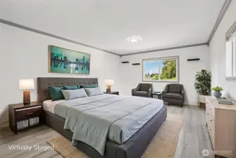 Spacious primary bedroom at 4612 N 21st St, Tacoma, WA — virtually staged to showcase its generous layout, wide-plank flooring, large windows with natural light, and flexible space for a sitting area or home office. This North Tacoma retreat offers comfort, privacy, and room to personalize with modern finishes throughout.