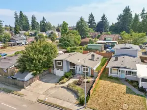Aerial front view of 4612 N 21st St, Tacoma, WA — showcasing the home’s split-level design, attached garage, landscaped front yard, extended driveway, and fully fenced backyard. Located in a desirable North Tacoma neighborhood near parks, schools, shopping, and commuter routes, this property offers convenience and a welcoming residential setting. No HOA!