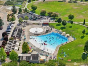 Aerial view of Kandle Park, just minutes from the home — featuring a popular community pool, lazy river, splash pad, playground, walking paths, and wide-open green space. A fantastic neighborhood amenity for outdoor fun, relaxation, and family activities.