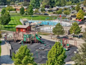 Aerial view of Kandle Park, just minutes from the home — featuring a popular community pool, lazy river, splash pad, playground, walking paths, and wide-open green space. A fantastic neighborhood amenity for outdoor fun, relaxation, and family activities.