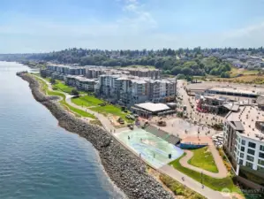 Aerial view of Point Ruston—Tacoma’s vibrant waterfront destination—featuring miles of scenic shoreline trails, dining, shopping, entertainment, and family-friendly recreation. Just a short drive from the home, offering easy access to some of the area’s most desirable amenities and Puget Sound views.