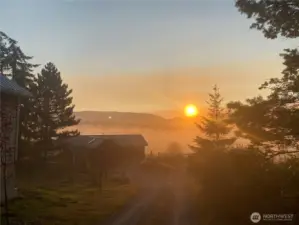 Early morning sunrise over the valley blanketed in fog, offering promises for the day.