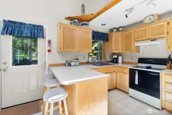 Kitchen view showcasing the open layout to living and dining areas.