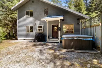 Backyard relaxation area featuring the private hot tub.