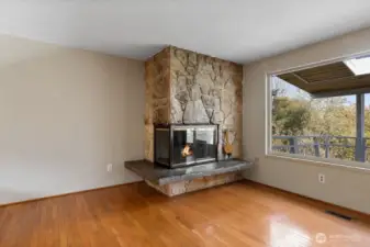 The fireplace is definitely the focal point of the living room. Notice the huge picture window!