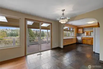 Looking from the living room into the dining room & kitchen. Enjoy your view of Foster Links Golf Course from the covered deck.