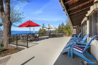 This massive deck extends your entertainment space to the outdoors where blue sky and water are your backdrop.