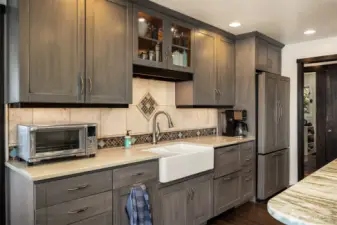 Custom paneled fridge seamlessly blends with surrounding cabinetry for a clean cohesive look.