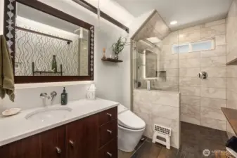A wonderful three-quarter bath on the main level offers a zero-entry shower with stylish custom tile from floor to ceiling.