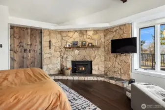 A warm fireplace surrounded by stonework will bring warmth and ambiance to the room.