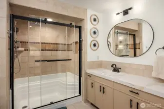 Spa like primary bath is full of luxurious features to pamper you. You'll love the oversized walk-in shower with a built-in seat surrounded by custom tile and handsome fixtures.