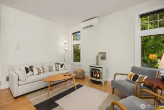 A new mini-split system efficiently heats and cools the space, and the back windows frame views of the green space behind the cottage.