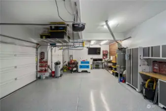 Epoxy floors and updated lighting and storage in this 3 car garage!