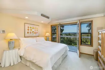 Upper level primary bedroom with private balcony.