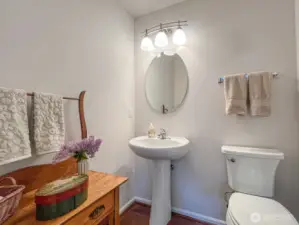 Charming main floor powder room is steps away from the great room and big enough for decorative furniture (as shown).