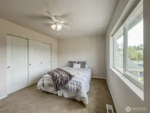 A light-filled, west facing upstairs bedroom with ample closet space - located near the top of the stairs and adjacent to the full bath.