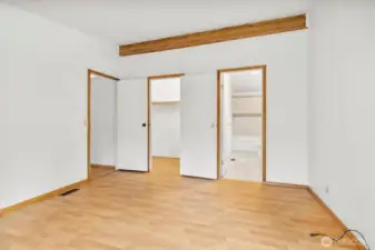 Large walk-in closet and full bathroom in primary bedroom