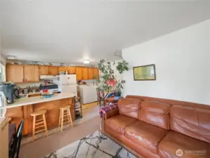 Living room/kitchen/washer and dryer in unit 2.