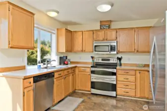 Light and bright kitchen with Stainless steel appliances and a double oven.