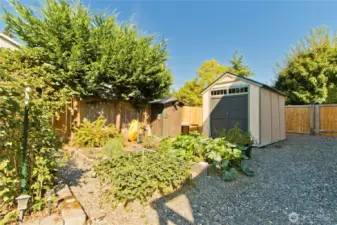 Side yard with raised  garden beds and shed