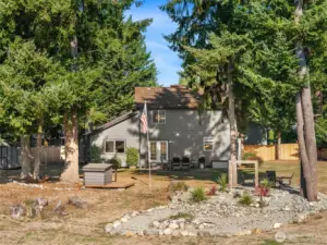 Water feature & rock garden with cozy fire pit.
