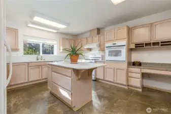 Bright and spacious kitchen has abundant cabinetry with full-extension drawers and under-cabinet lighting