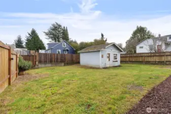Hobby Shed in the backyard has a concrete floor and power.  Moss Killer has been applied to the roof-- needs some TLC but dry inside.  Wood fencing provides maximum privacy.