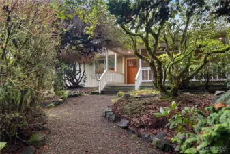 Grand Entrance Through Mature Landscaping to Front Door