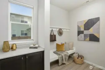 Mudroom with built-in storage, butler's pantry and additional HUGE pantry at the end of this hallway. (some items digitally staged)